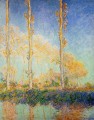 Tres álamos en el paisaje otoñal de Claude Monet
